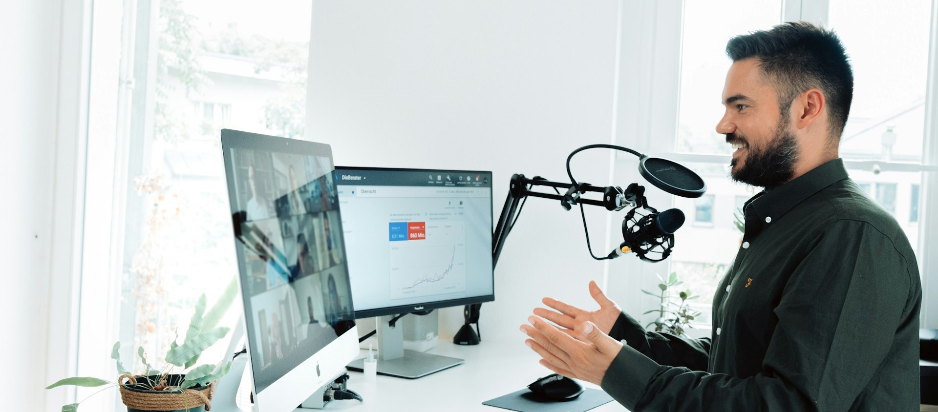 man in black jacket holding black corded computer mouse