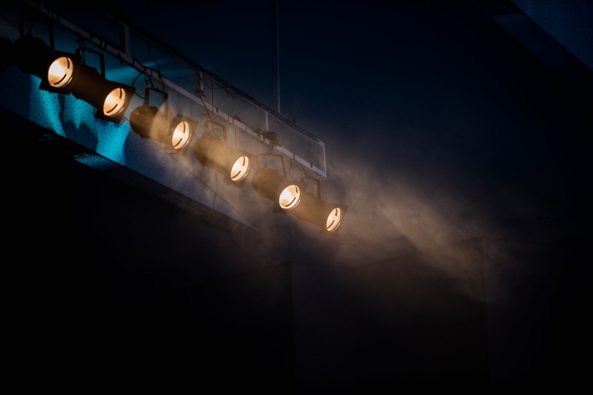 Moody stage lighting with smoke effect to add atmospheric drama.