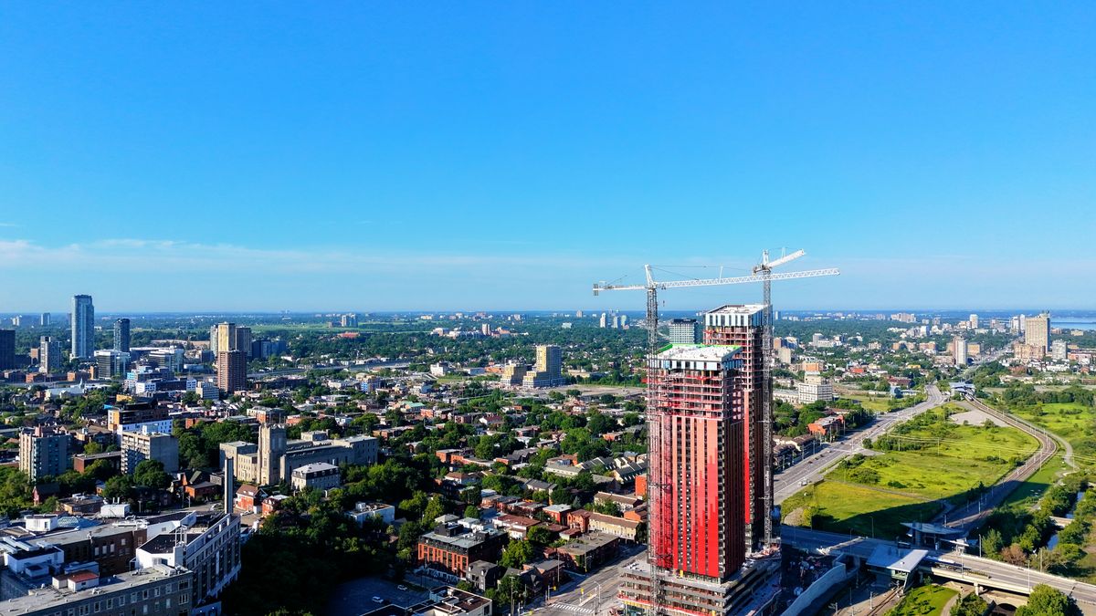 Aerial view of an urban landscape with a prominent construction site towering over the cityscape.